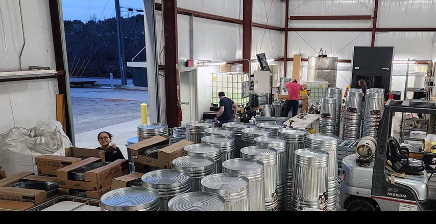 Assembly of the steel roll carts at the UGA New Materials Institute in late January. From left:  
Mira Ngoc Le, Michael Kandefer, Shawn Wallbillich and Austin Wright. Photo by Evan M. White
