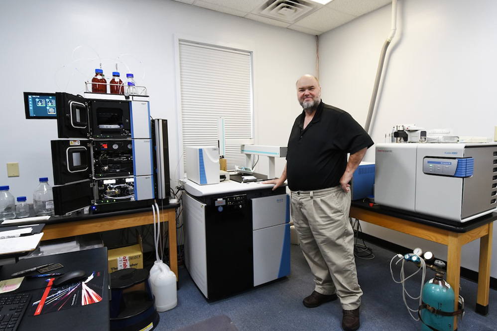 Jay Brandes stands with the new isotope ratio mass spectrometry system in the Skidaway Island Stable Isotope Laboratory. (Photo by Jackson K. Schroeder)
